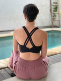 caraucci stretchy full coverage black yoga bra top with criss cross back straps #color_black