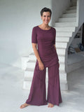 women's skirt-over purple wide leg pants with raised diagonal stitching shown with purple short sleeve ruched top #color_jam